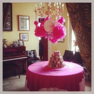 The cupcake tower had it's own place of pride under the chandelier of tissue poms. The pink tablecloths were festooned with a scattering of gold sequins. 